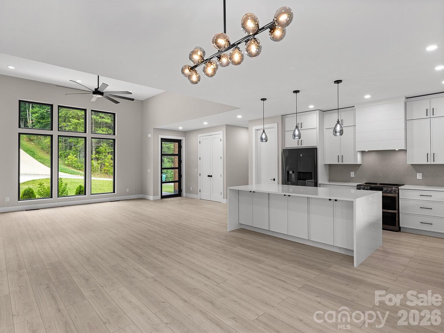 Gourmet kitchen with island and pendant lighting
